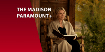 A atriz Michelle Pfeiffer sentada em uma cadeira de balanço de madeira em uma varanda rústica, segurando um livro. Ao lado, uma faixa vermelha com o texto "The Madison Paramount+". O cenário ao fundo sugere uma paisagem rural outonal.