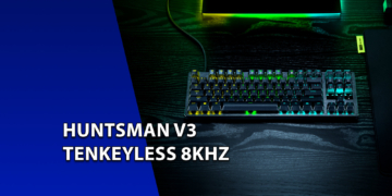 Teclado mecânico gamer Razer Huntsman V3 Tenkeyless com iluminação RGB verde sobre uma mesa de madeira escura. À esquerda, uma faixa azul inclinada com o texto "HUNTSMAN V3 TENKEYLESS 8KHZ".